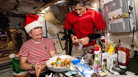 December 2024 - NASA astronauts Nick Hague and Suni Williams, Expedition 72 flight engineer and commander respectively, share snacks and goodies on Christmas Eve inside the gallery of the International Space Station's Unity module - Photo: Geopix/NASA