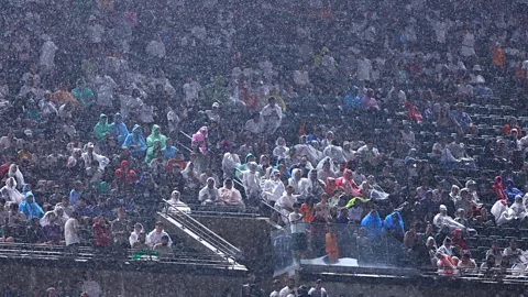 Getty Images A crowd wearing rain ponchos in the stands at a football stadium (Credit: Getty Images)