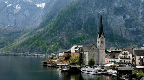 Hallstatt Village in Austria, surrounded by the Alps mountains. The village is like something out of a fairytale, with buildings sitting on the edge of the water