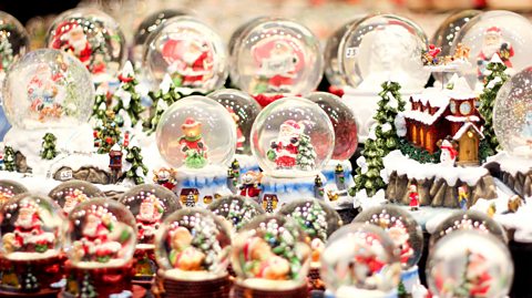 A table full of Christmas snow globes - Santa and reindeer - at a Christmas market in Vienna