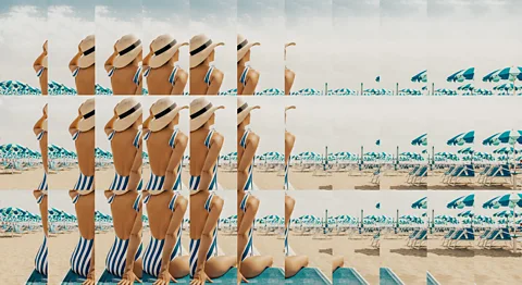 Edouard Taufenbach Bastien Pourtout/ Getty Images A woman sits on a beach wearing a striped swimsuit and straw hat. The image looks as though it is fractured as if by time (Credit: Edouard Taufenbach Bastien Pourtout/ Getty Images)