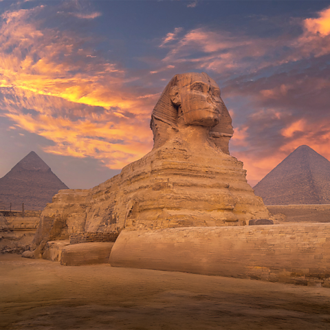 A photo of the Great Sphinx and the pyramids in the background.