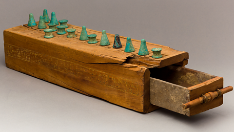 A photo of Senet game pieces from the Met Collection.