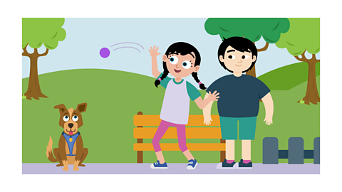 Olive throwing the ball for Patch. Malakai stands next to her.