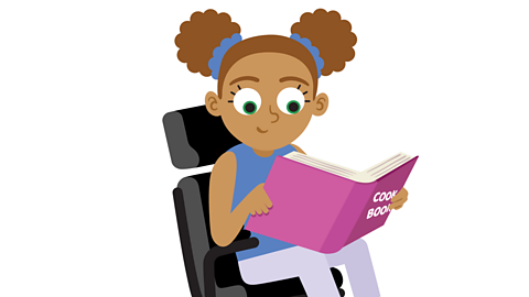 A girl is reading a cookbook.