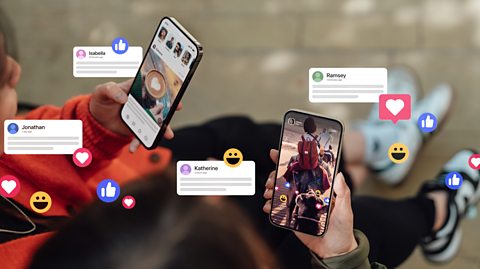 Two female hands holding their smartphones, connecting with social media, leaving comments, sending messages and sharing photos