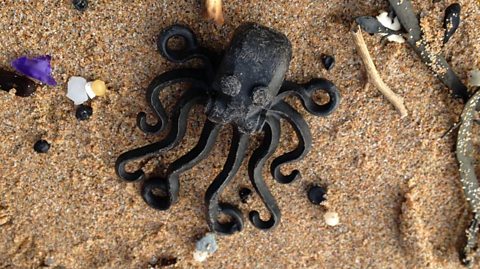 Lego octopus on a beach.