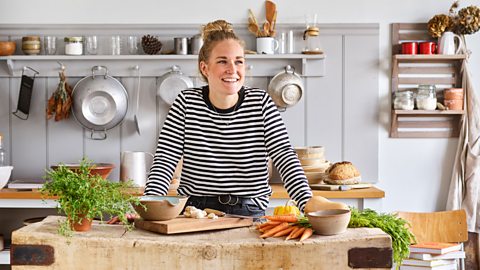 Helen Upshall stood in her kitchen with carrots and herbs on the table in front of her