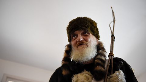 Historian Richard Nearhood wears the fur hat and carries the sticks of Belsnickel