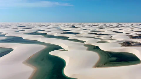 Getty Images The iconic pattern of white sand dunes and seasonal lagoons is formed by strong coastal winds and filled during the rainy months (Credit: Getty Images)