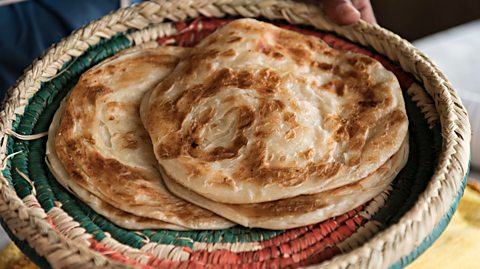 A tray with parathas piled up