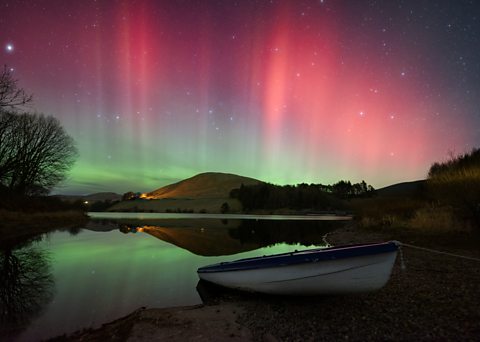 Image of extremely strong aurora over Castlehill Reservoir, Scotland