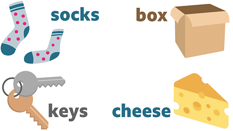 a pair of blue socks with pinks spots, a cardboard box, two keys and a block of cheese