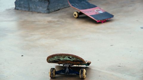 An image of a broken skateboard.