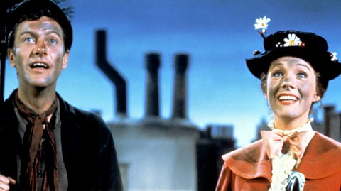From left to right, Dick van Dyke as Bert and Julie Andrews as Mary Poppins in a still from Chim Chim Cher-ee. Both have soot on their faces.