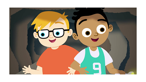 Two boys in a cave smiling
