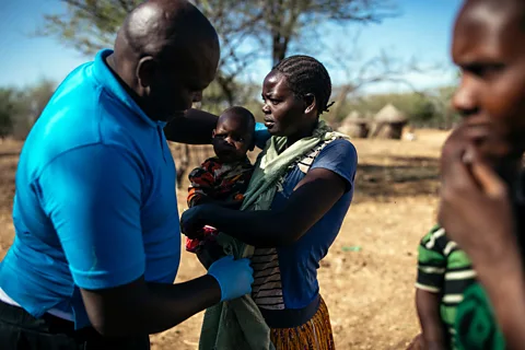 Kang-Chun Cheng During his visits, Ochieng palpates the spleens of villagers during examinations as this can give an early indication of visceral leishmaniasis (Credit: Kang-Chun Cheng)