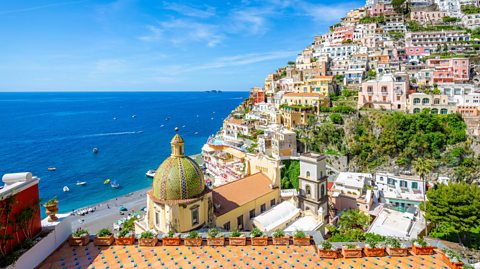 Positano, Amalfi Coast in Italy. A view of the sea and all the colourful buildings and homes on the cliffside