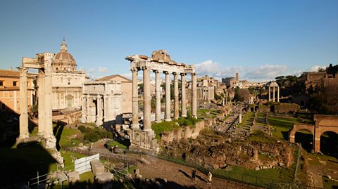 The Roman Forum in Rome, Italy on a sunny day - a rectangular forum with ancient columns, buildings and ruins 