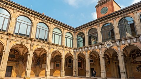 Palace of Archiginnasio, once the main building of University of Bologna. In a square, the building has identical archways to walk through and large glass windows above