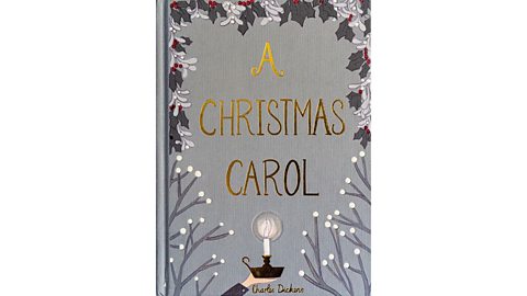 Book cover of A Christmas Carol by Charles Dickens featuring a grey background with holly leaves, berries, and a candle in the center.
