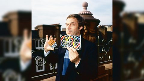 Erno Rubik holding up a Rubik's cube