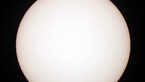 Getty Images Mercury is truly tiny compared to the other planets – it can be seen here transiting across the face of the Sun as a dot on the left-hand side (Credit: Getty Images)