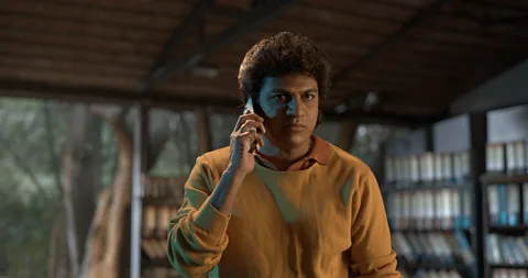 MG Srinivas A young man holding a mobile phone (Credit: MG Srinivas)