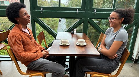 Home educated teenagers Anree and Malaya discussing higher education in a cafe