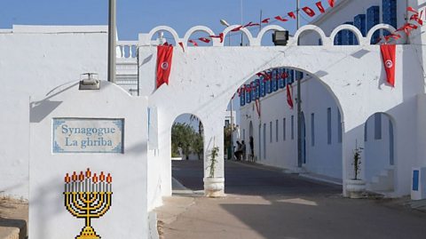 Simple whitewashed exterior of the El Ghriba Synagogue on the isle of Djerba, Tunisia