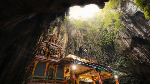The Cathedral Cave is the largest of the cavern complex, natural light shines on the Hindu shrines
