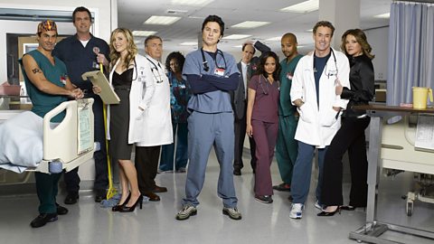 The full cast of Scrubs pose for a publicity photo in a hospital setting