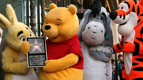 From left to right, Rabbit, Winnie the Pooh, Eeyore and Tigger. Pooh is holding a plaque to commemorate receiving a Walk of Fame star in Hollywood
