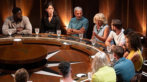 An image of discussion taking place around the round table in an episode of The Traitors