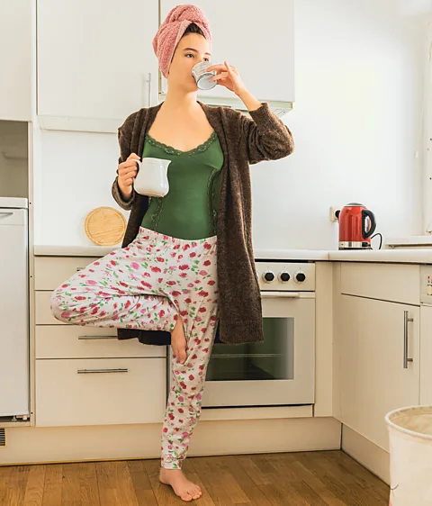 Getty Images Standing on one leg during daily tasks can be time-efficient way of improving your balance – just make sure you are confident before reaching for hot drinks (Credit: Getty Images)