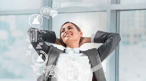 Business person leans back in relaxation as a holographic appears in front of them with their online apps, from email, messages, clock, maps etc.