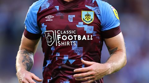 A Burnley player wearing the claret and blue home shirt, sponsored by Classic Football Shirts