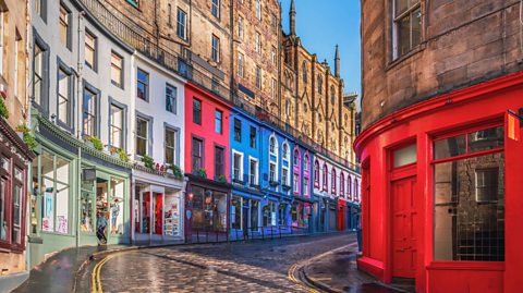 Victoria Street in Edinburgh. The winding road is full of old buildings, all painted in various colours next to one another