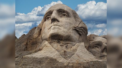 The head of George Washington, President of the United States, sculpted into the granite rock of Mount Rushmore.