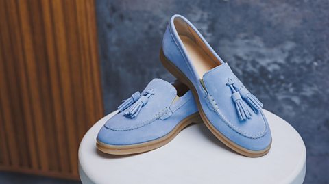 A close up of blue moccasin shoes