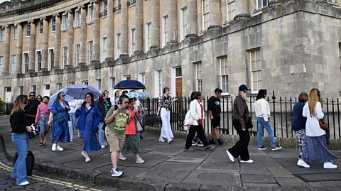 Tourists in Bath looking at the Bridgerton filming locations a the famous Royal Crescent