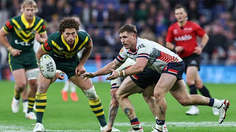 England player AJ Brimson passes the ball to his left, with Australia's Mark Nawaqanitawase watching close by