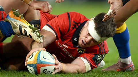 Tom Farrell of Munster tees a ball up to be recycled after a ruck