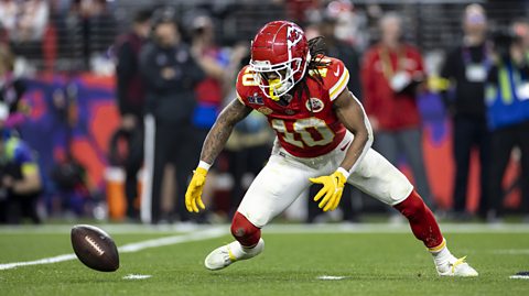 Kansas City Chiefs player Isiah Pacheco fumbles the ball and looks at it desperate to retrieve