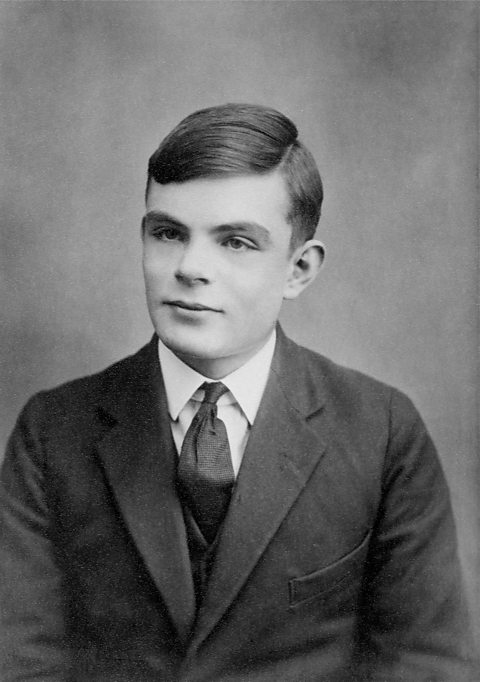 A black and white photograph of Alan Turing