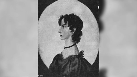 A black and white illustration of the left-hand side profile of Anne Brontë. She is expressionless with her curly hair in a bun with pieces falling in the front of her face. She wears a plain, black necklace and a dark dress with puffed sleeves