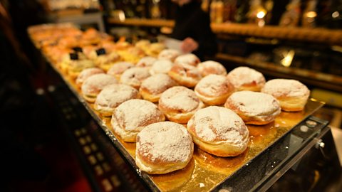 Trays with multiple doughnuts in a shop in Poland