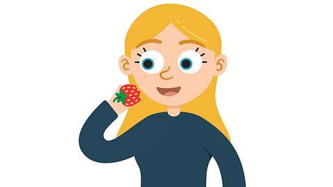A girl eating a strawberry.