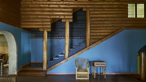 Interior with wooden staircase and blue walls (Credit: Richard Powers/ The Iconic Nordic House)