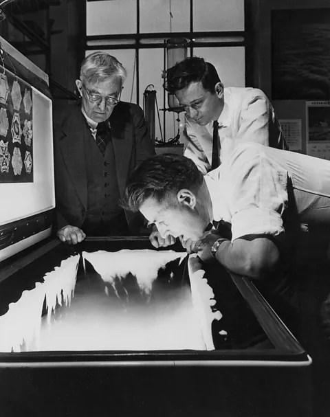 Getty Images US chemist Vincent Schaefer, who demonstrated and trialled the idea of cloud seeding, tries to turn his exhaled breath into crystals in 1949 (Credit: Getty Images)